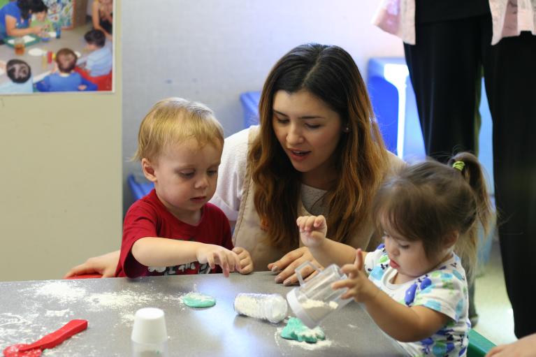 Care Educator with two children at a table